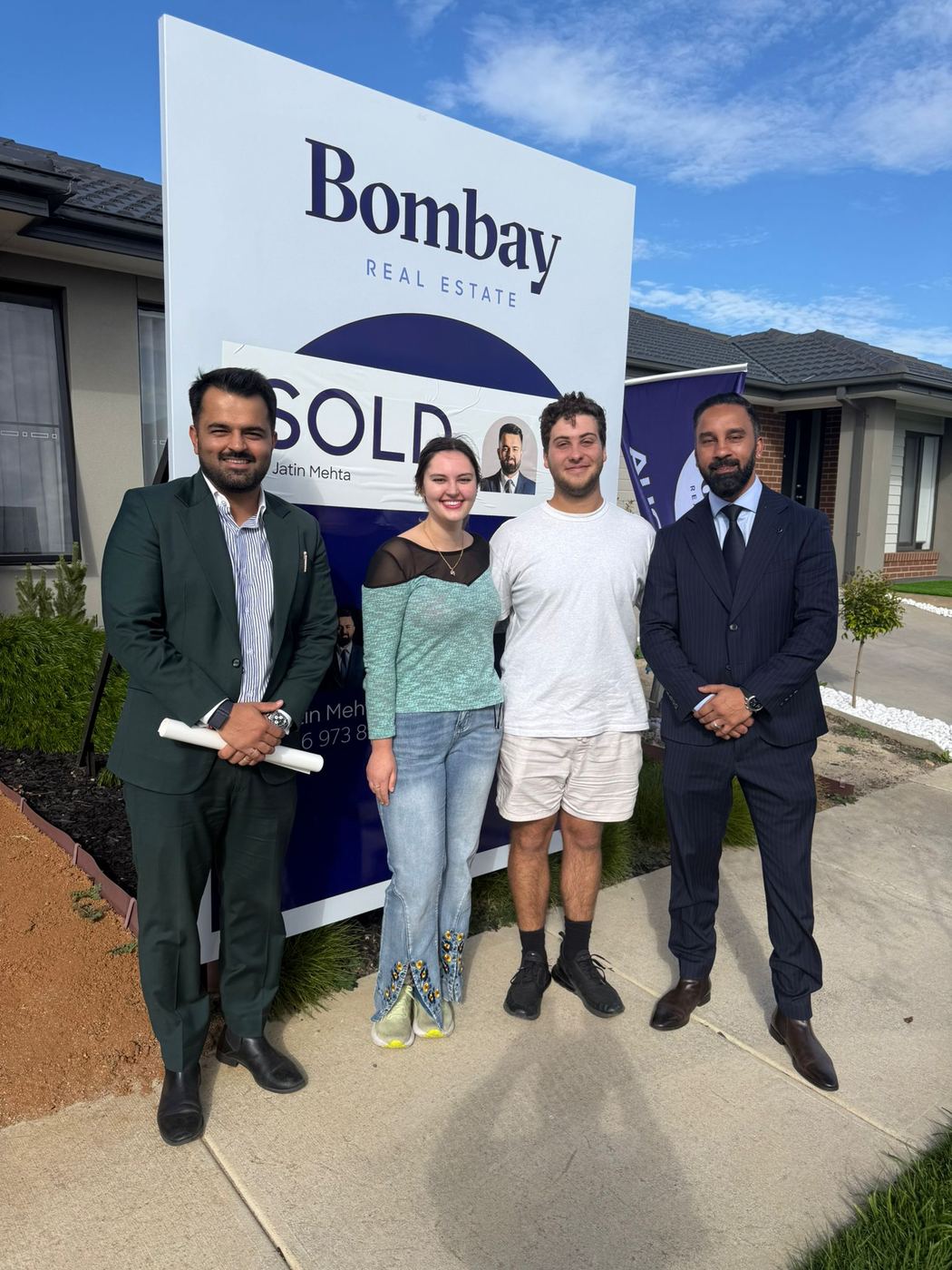 Buyers and sellers at Bombay Real Estate sold boards